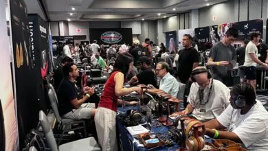 Exhibition hall filled with attendees testing high-end headphones at crowded CanJam SoCal show floor