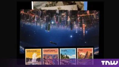 An inverted cityscape postcard placed above four national park postage stamps against a dark background.