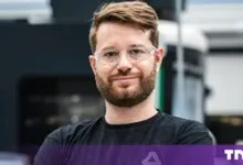 Theo Saville, co-founder of CloudNC, wearing safety glasses inside a manufacturing facility.