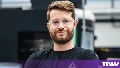 Theo Saville, co-founder of CloudNC, wearing safety glasses inside a manufacturing facility.
