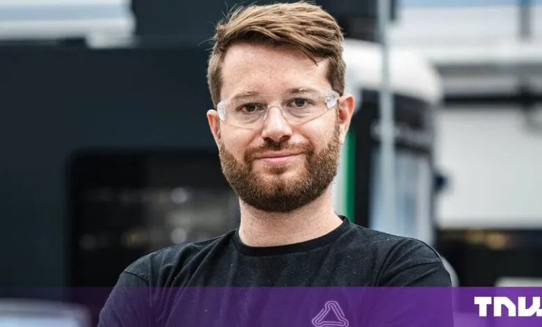 Theo Saville, co-founder of CloudNC, wearing safety glasses inside a manufacturing facility.
