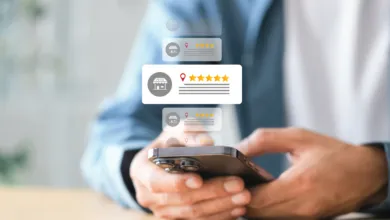 Close-up of hands using a smartphone with floating local business review icons and star ratings.