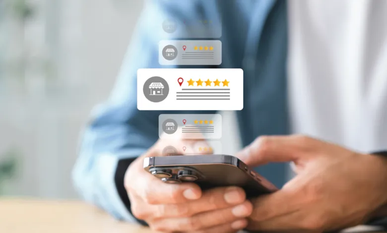 Close-up of hands using a smartphone with floating local business review icons and star ratings.