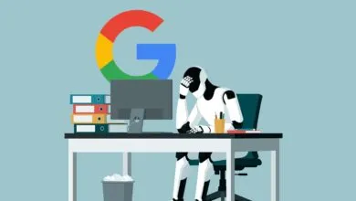 A frustrated robot sits at a desk working on a computer beneath a Google logo.