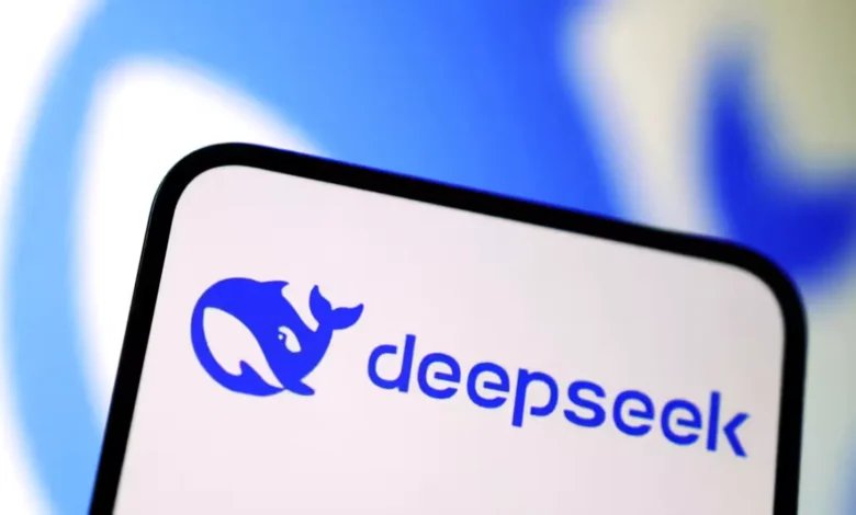 Close-up of a smartphone displaying the DeepSeek logo: a blue whale and the company name in blue text on a white background.