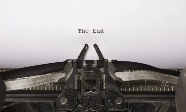 Close-up of a vintage typewriter with the words 'The End' typed on the page.