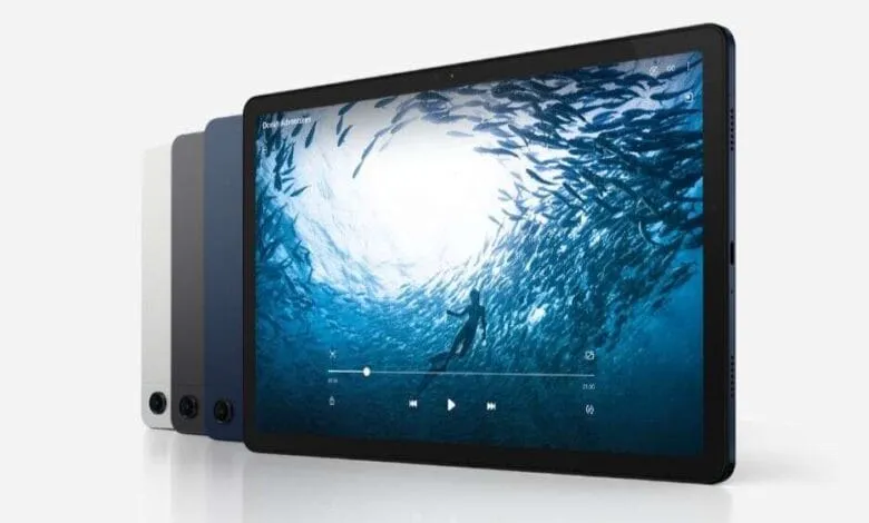 A dark blue Galaxy Tab A9 displays an underwater video of a diver surrounded by fish. Three other tablets in gray and silver are shown beside it.