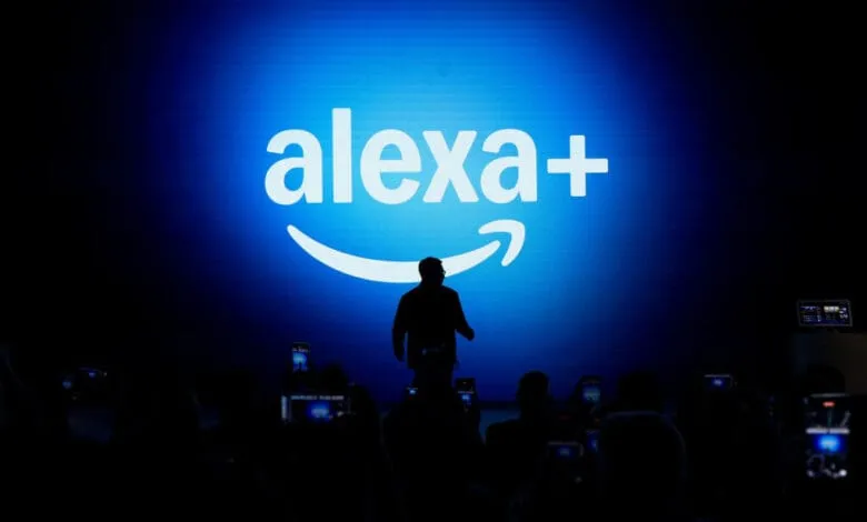 Silhouetted figure on stage at Alexa+ unveiling, large blue screen displays the logo.