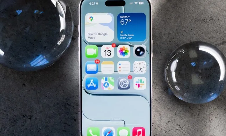 iPhone mockup showcasing iOS interface with weather, maps, and various apps displayed on the screen, surrounded by glass spheres on a dark surface.