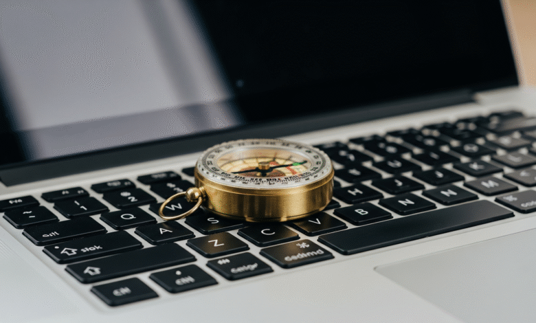Brass compass resting on a laptop keyboard, symbolizing online navigation or direction.