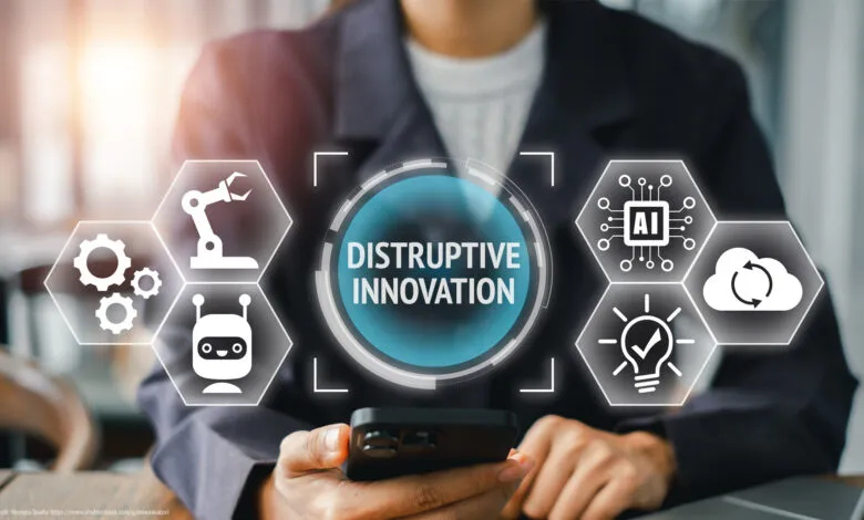 Person holding phone displaying 'Disruptive Innovation' with AI, robotics, and cloud computing icons.