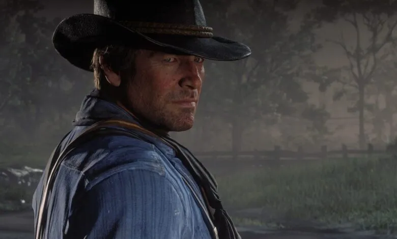 Close-up of Arthur Morgan from Red Dead Redemption 2 wearing a cowboy hat and blue shirt.