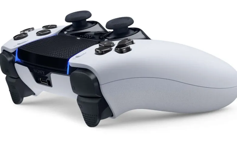 Close-up of a white Sony DualSense PlayStation 5 controller on a white background.