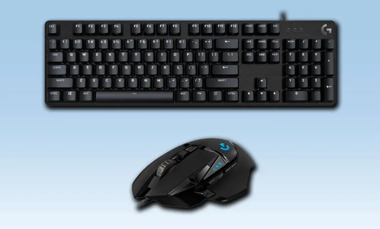 Black Logitech gaming keyboard and mouse on a light blue background.