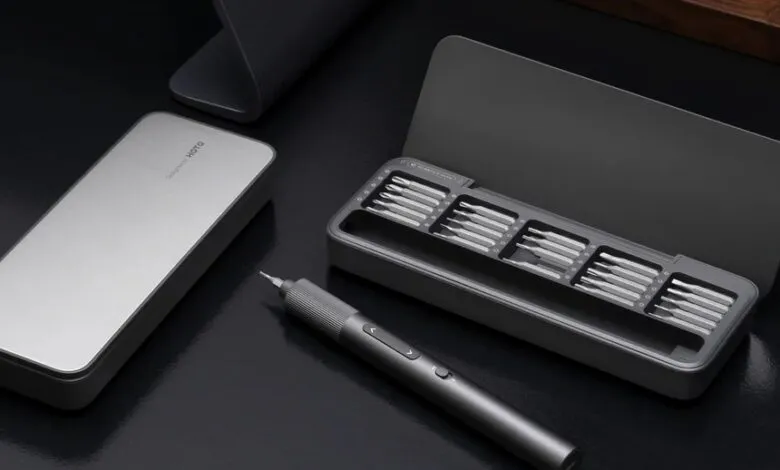 A sleek, modern electric screwdriver set with multiple bits in a gray case.