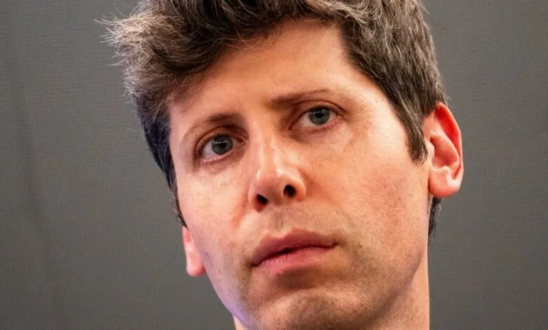 Close-up portrait of Sam Altman, looking slightly to the side.