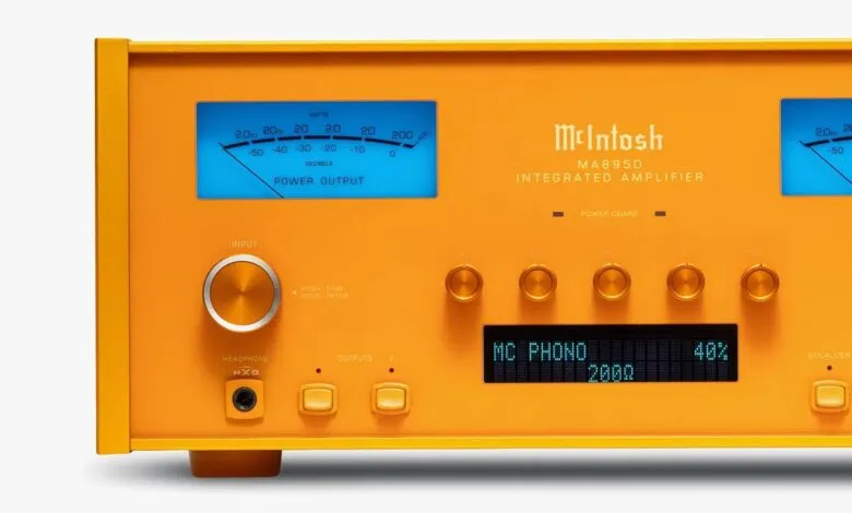 Close-up of a vibrant orange McIntosh MA8950 integrated amplifier with blue power output meters.