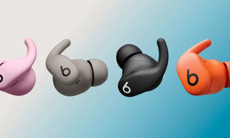 Four Beats Fit Pro wireless earbuds in pink, gray, black, and orange.