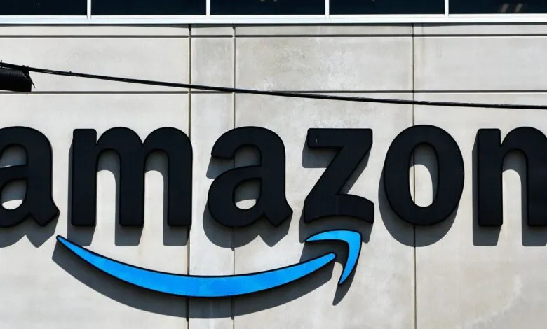 Amazon logo on a building, black letters with a blue arrow.