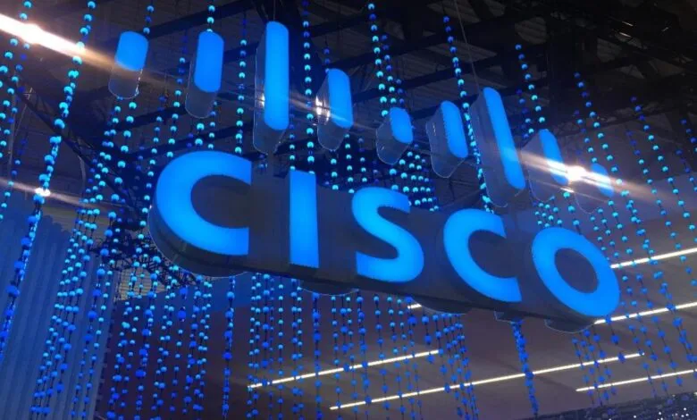 Large illuminated Cisco logo with blue string lights hanging around it.