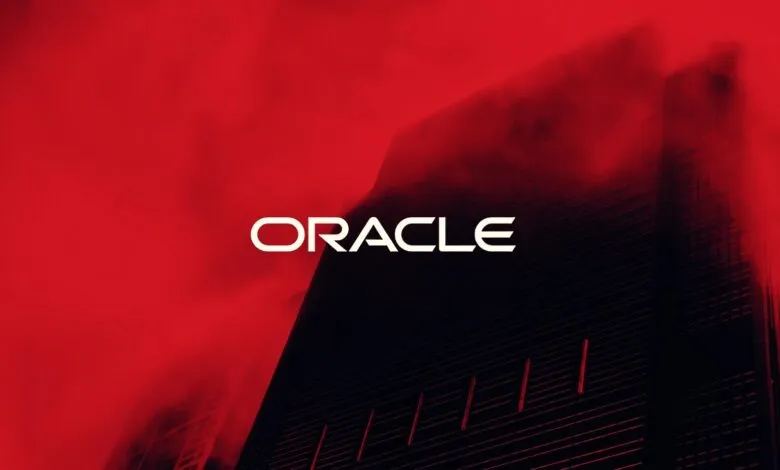 Oracle logo against a red and black building backdrop.