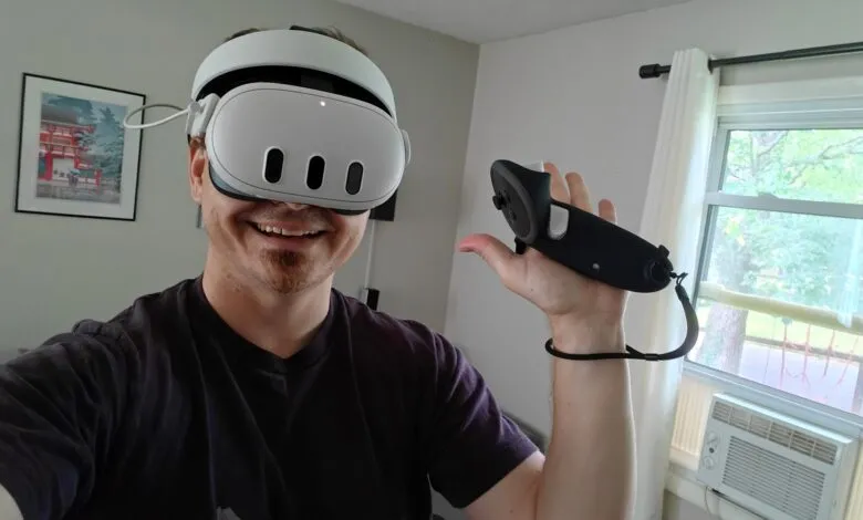 Person wearing VR headset and holding controller, smiling indoors.