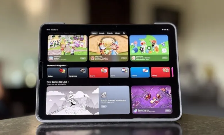 Tablet screen displaying Apple Arcade game interface with colorful game tiles and categories.