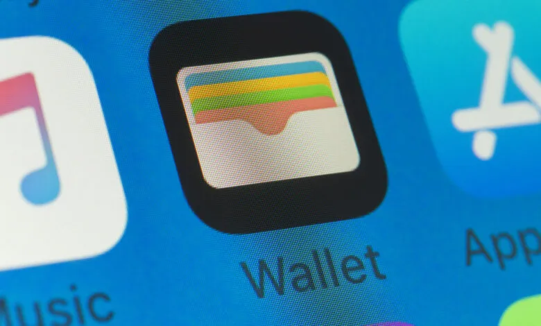 Close-up of iPhone screen showing Wallet, App Store, and Music app icons.