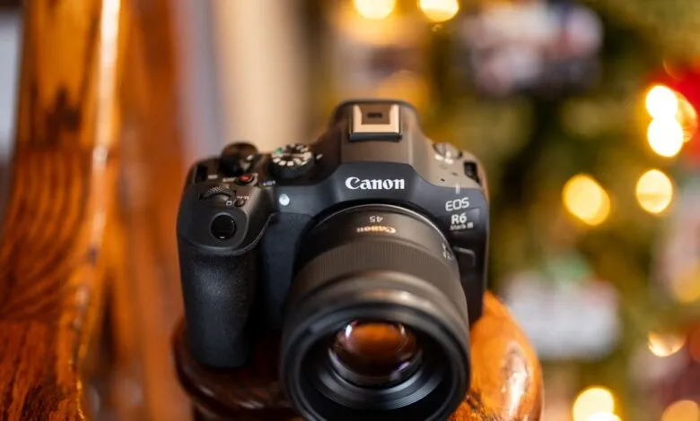 Canon EOS R6 Mark III camera with 45mm lens on wooden surface.