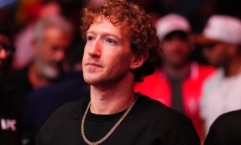 Mark Zuckerberg at UFC event, wearing black shirt and gold chain.