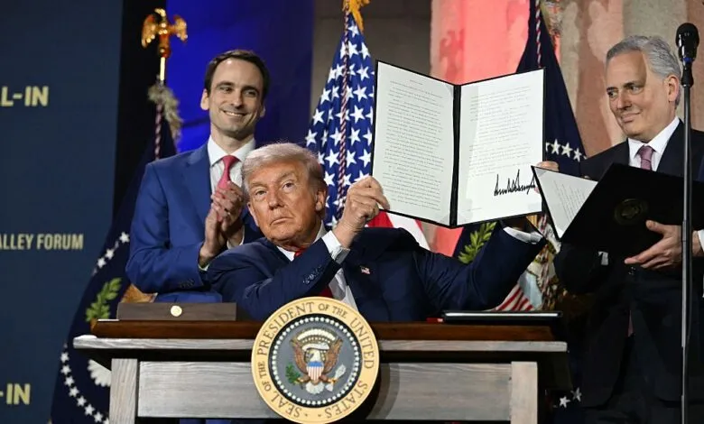 Donald Trump displays signed executive order at AI summit with aides.