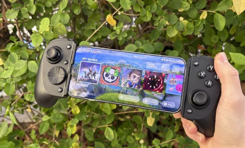Smartphone attached to a gamepad controller displaying a game menu.