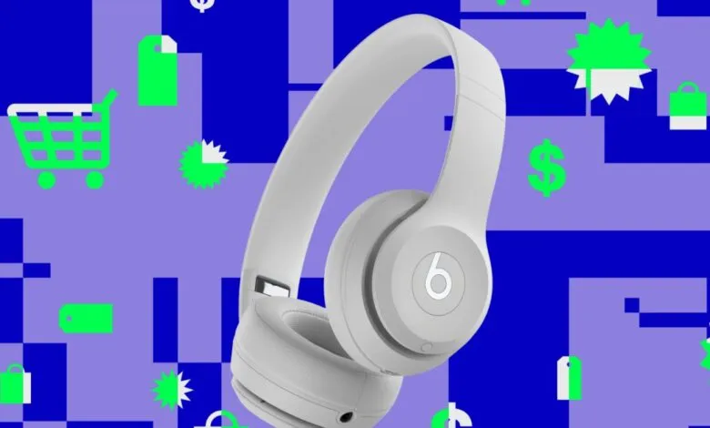 Beats Solo 4 headphones in white against a shopping-themed background.