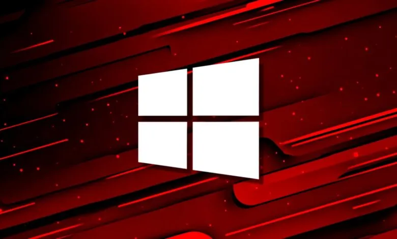 Windows logo in white against a red and black abstract background.