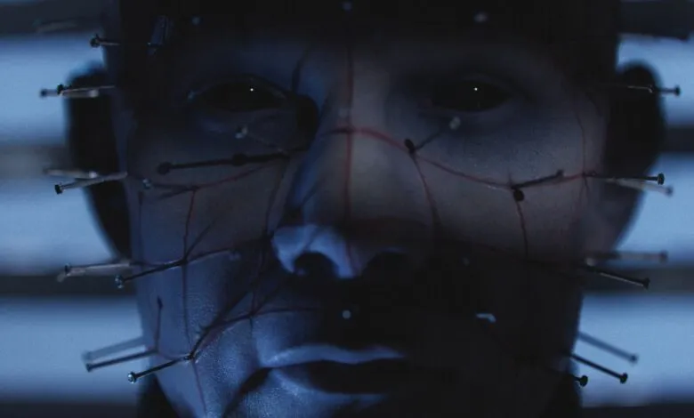 Close-up of Pinhead's face from Hellraiser, featuring pins and grid lines.