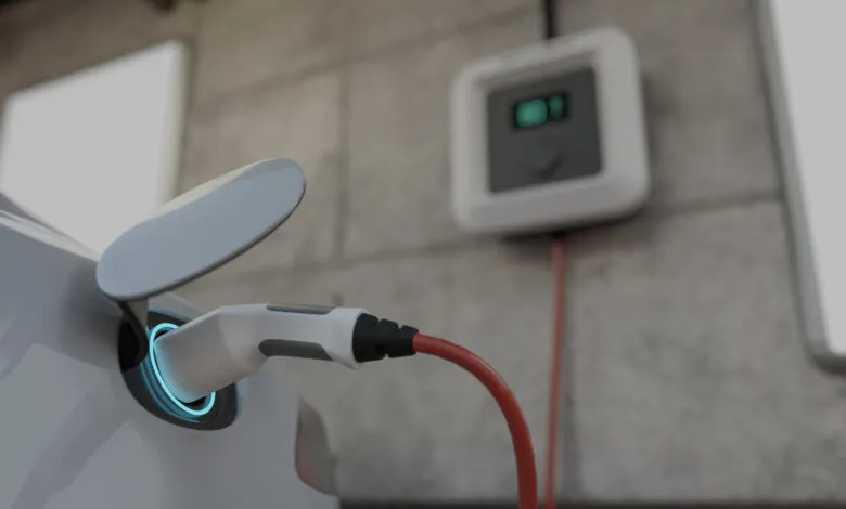 Electric car charging with a glowing blue port and wall-mounted charger.