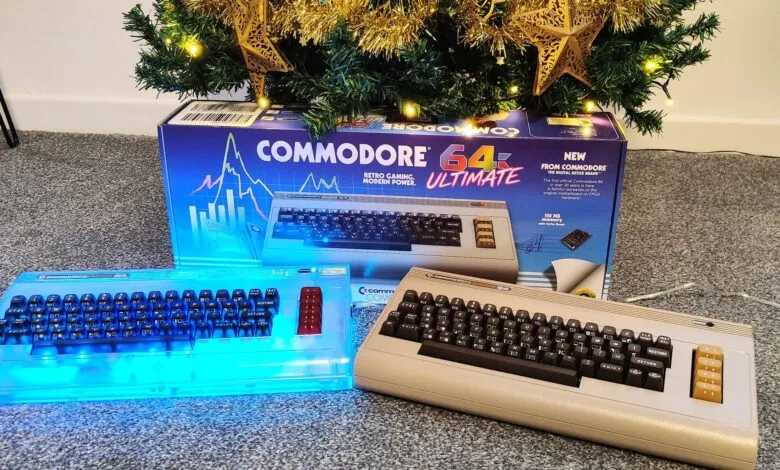 Commodore 64 Ultimate box and two computers under a Christmas tree.