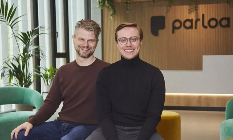 Two smiling men, Stefan Ostwald and Malte Kosub, founders of Parloa, pose indoors.