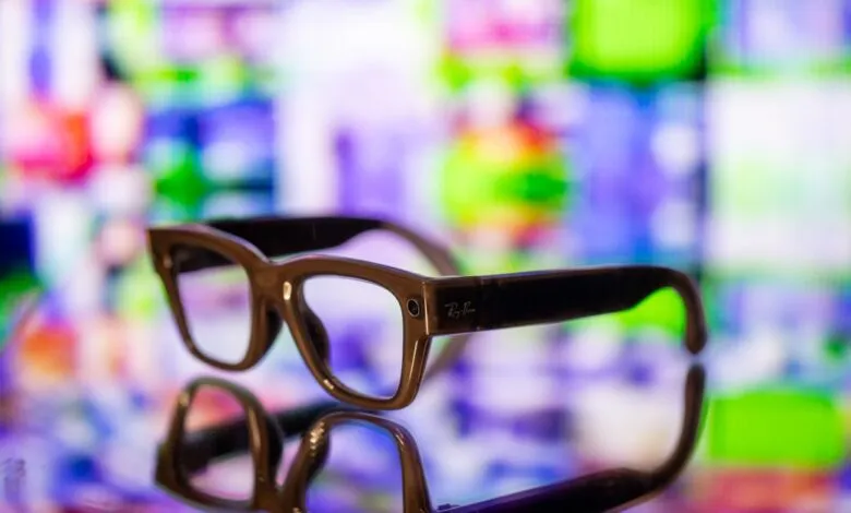 Ray-Ban smart glasses on reflective surface with colorful background.