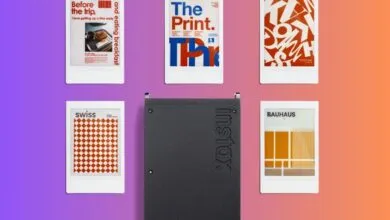 Instax printer surrounded by instant prints with graphic designs.