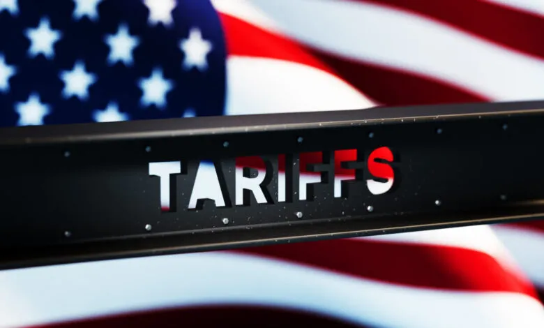 Steel beam with 'TARIFFS' cut out against American flag backdrop.