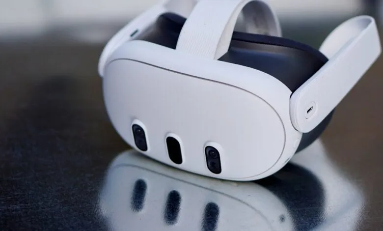 Close-up of a white Meta Quest Pro VR headset on a reflective surface.