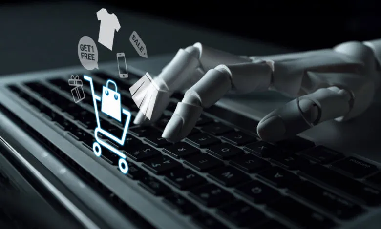 Robot hand types on laptop with shopping cart and sale icons.