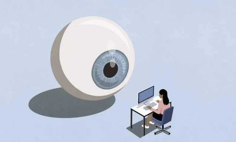 Large eyeball watches businesswoman working at her computer.