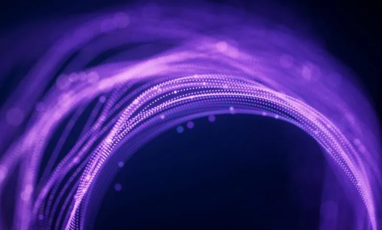 Abstract purple light trails forming a circular shape on dark background.