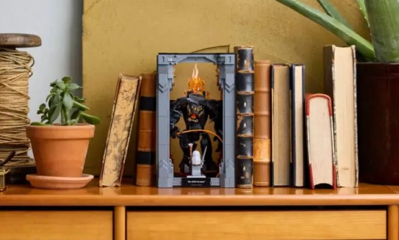LEGO Balrog book nook displayed between books on a wooden shelf.