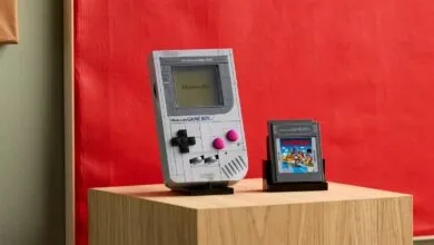 Lego Nintendo Game Boy with Super Mario Land cartridge on wooden surface.