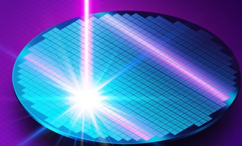 Silicon wafer with laser beam, used in semiconductor manufacturing.