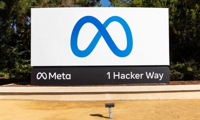 Meta headquarters sign with infinity logo and address: 1 Hacker Way.