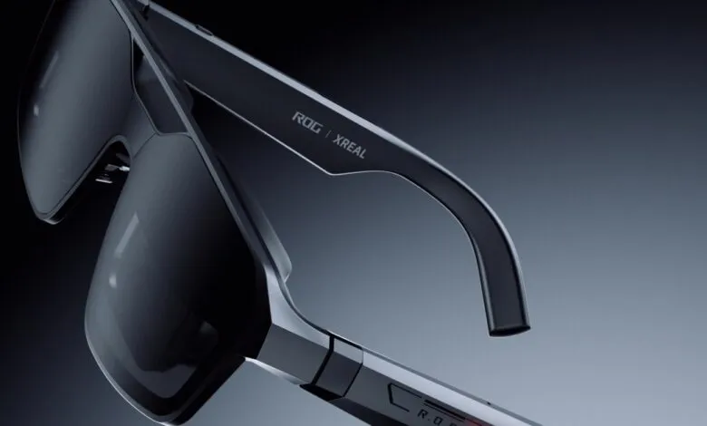Close-up of sleek ROG x XREAL AR glasses with dark lenses and futuristic design.